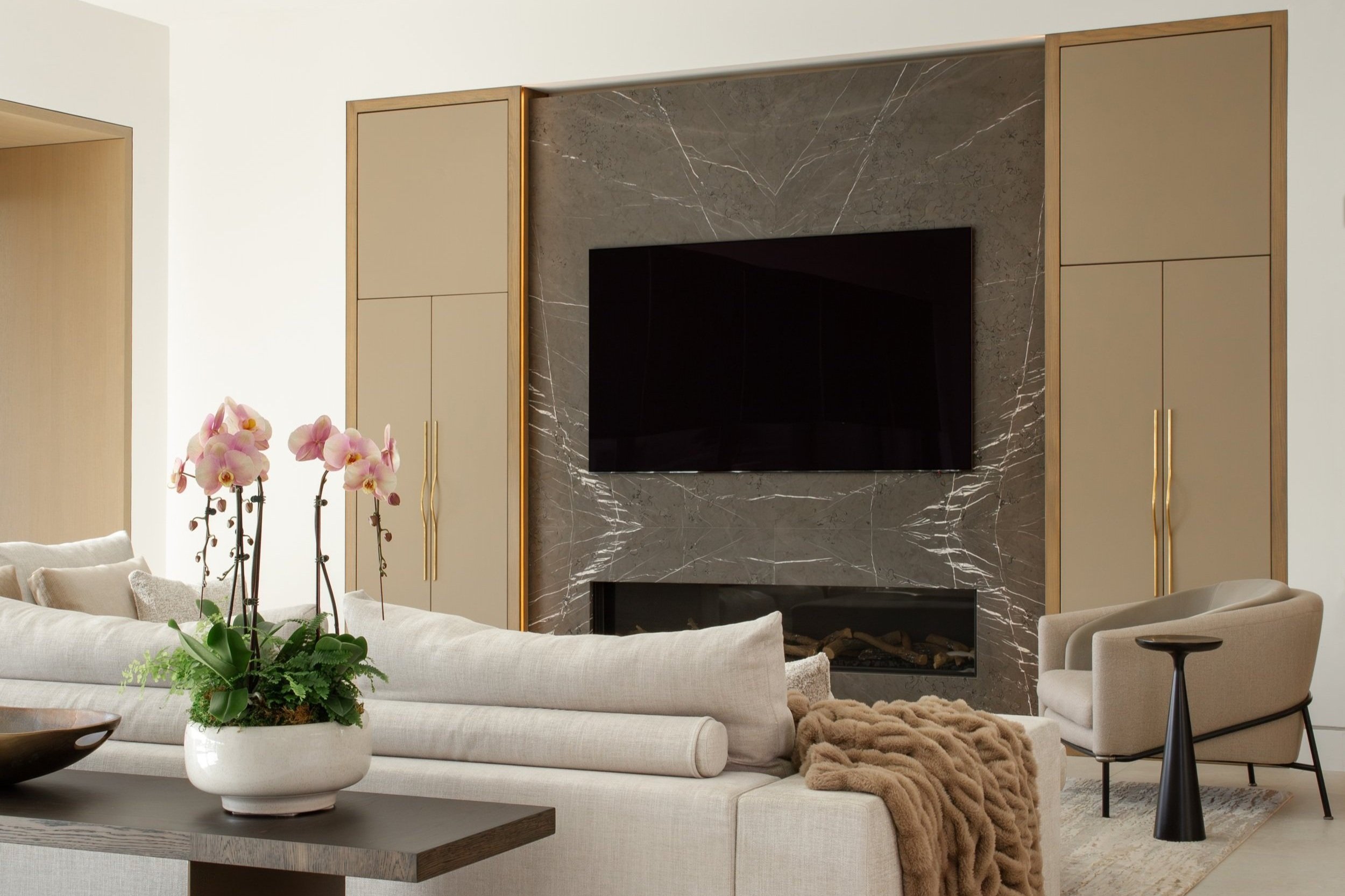 Luxury interior by Rockwell Interiors with floor-to-ceiling glass overlooking the Southern California coastline
