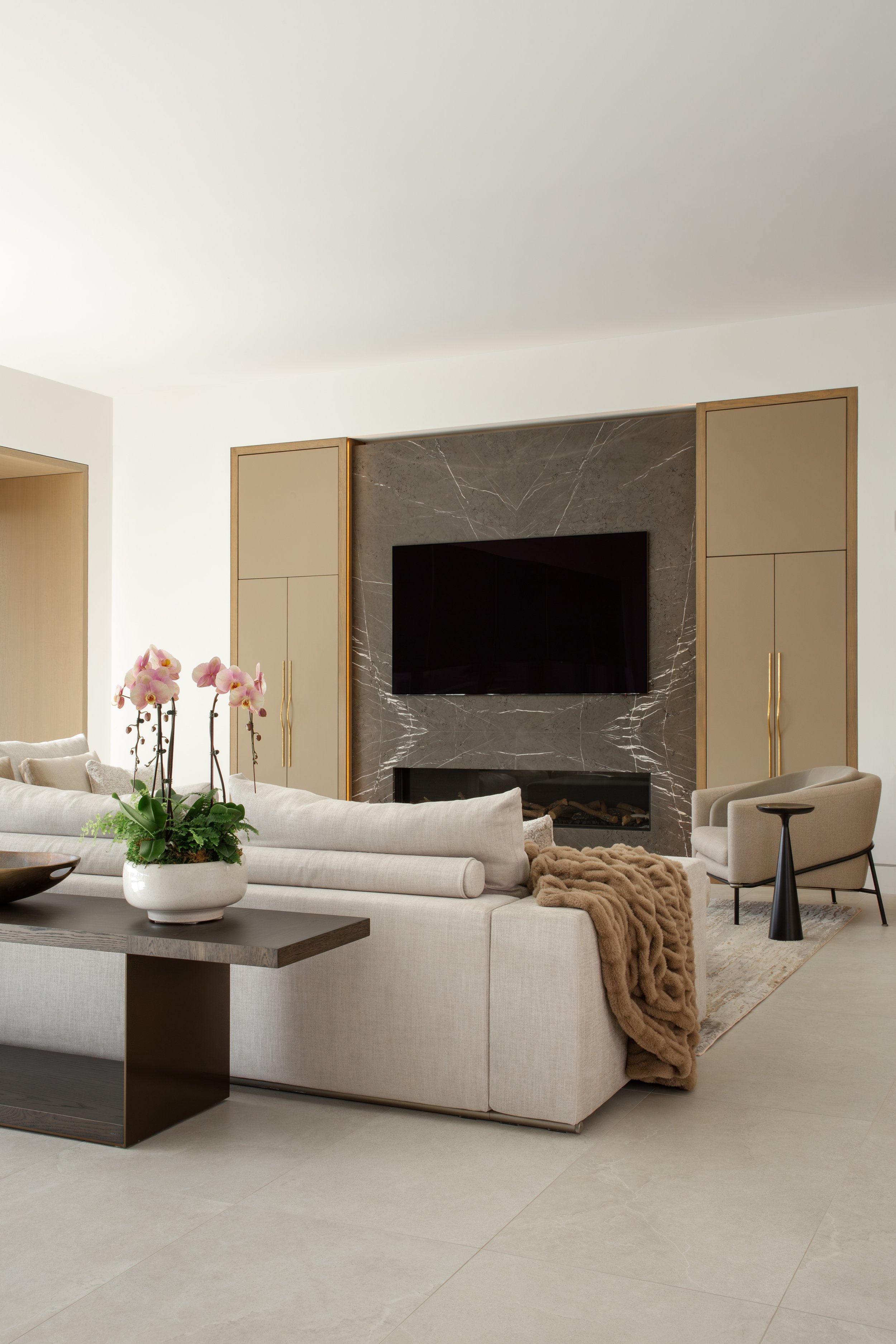 Indoor-outdoor living space with coastal view by Rockwell Interiors
